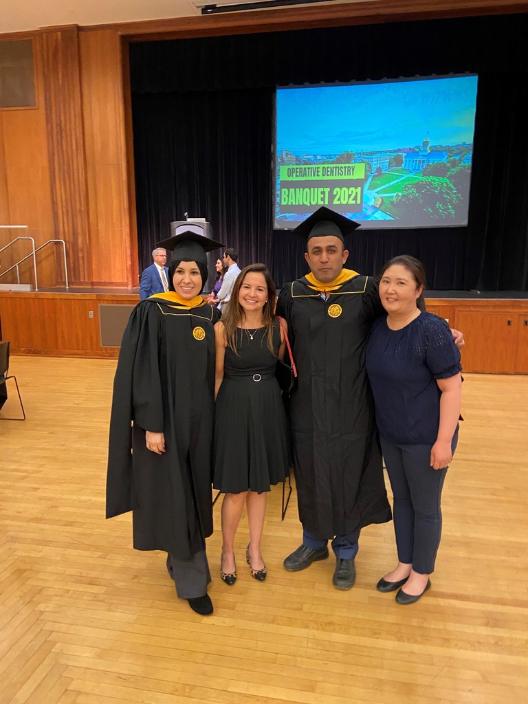 Three graduating students pose with Operative DEO Dr. Erica Teixeira.